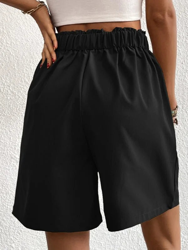 Black high-waisted shorts with a ruffled elastic waistband and a relaxed fit.
