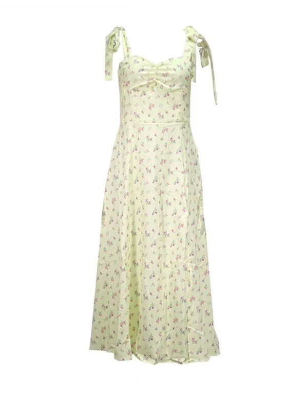 Light yellow midi dress with a delicate floral print and tie straps.