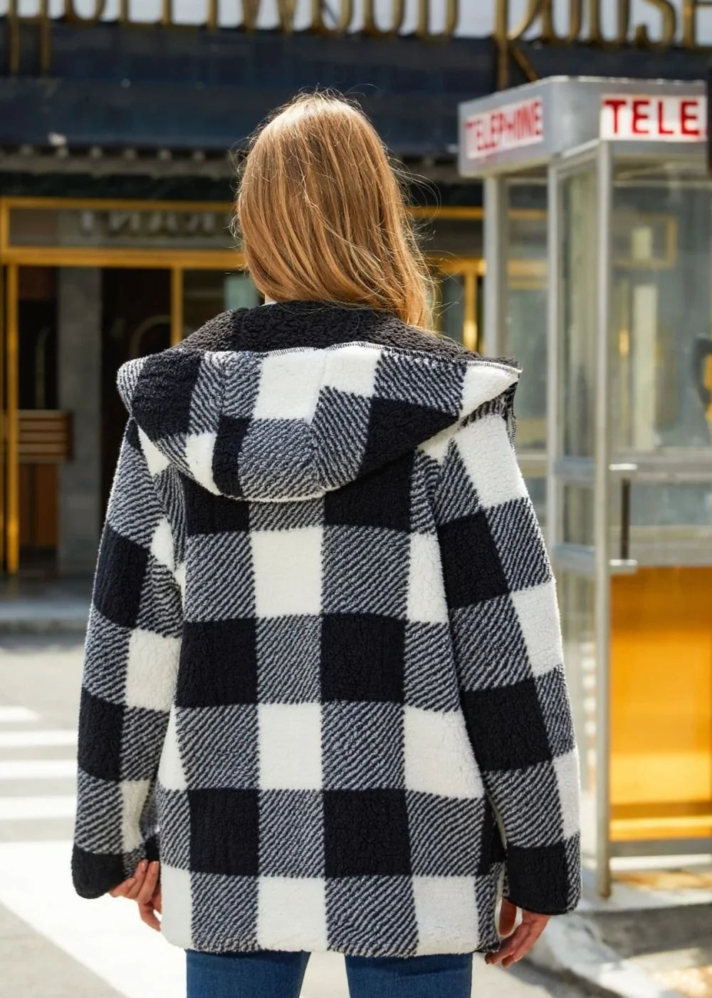 Back view of a black and white buffalo check fuzzy hooded jacket with a plush lining.