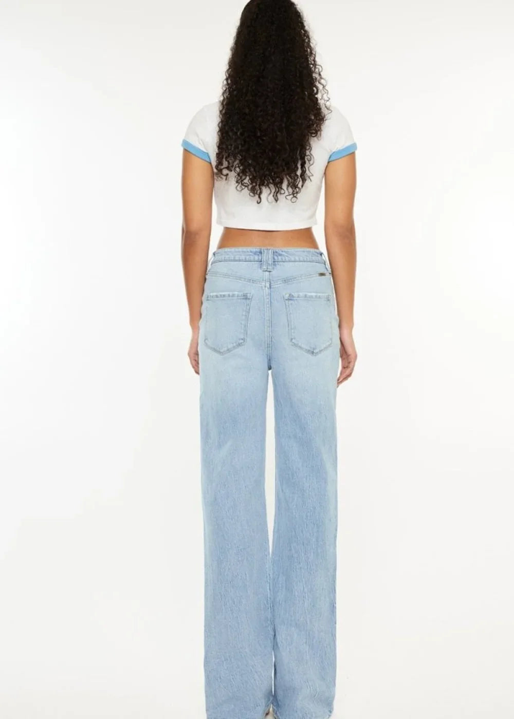 Close-up of distressed detailing on straight leg jeans