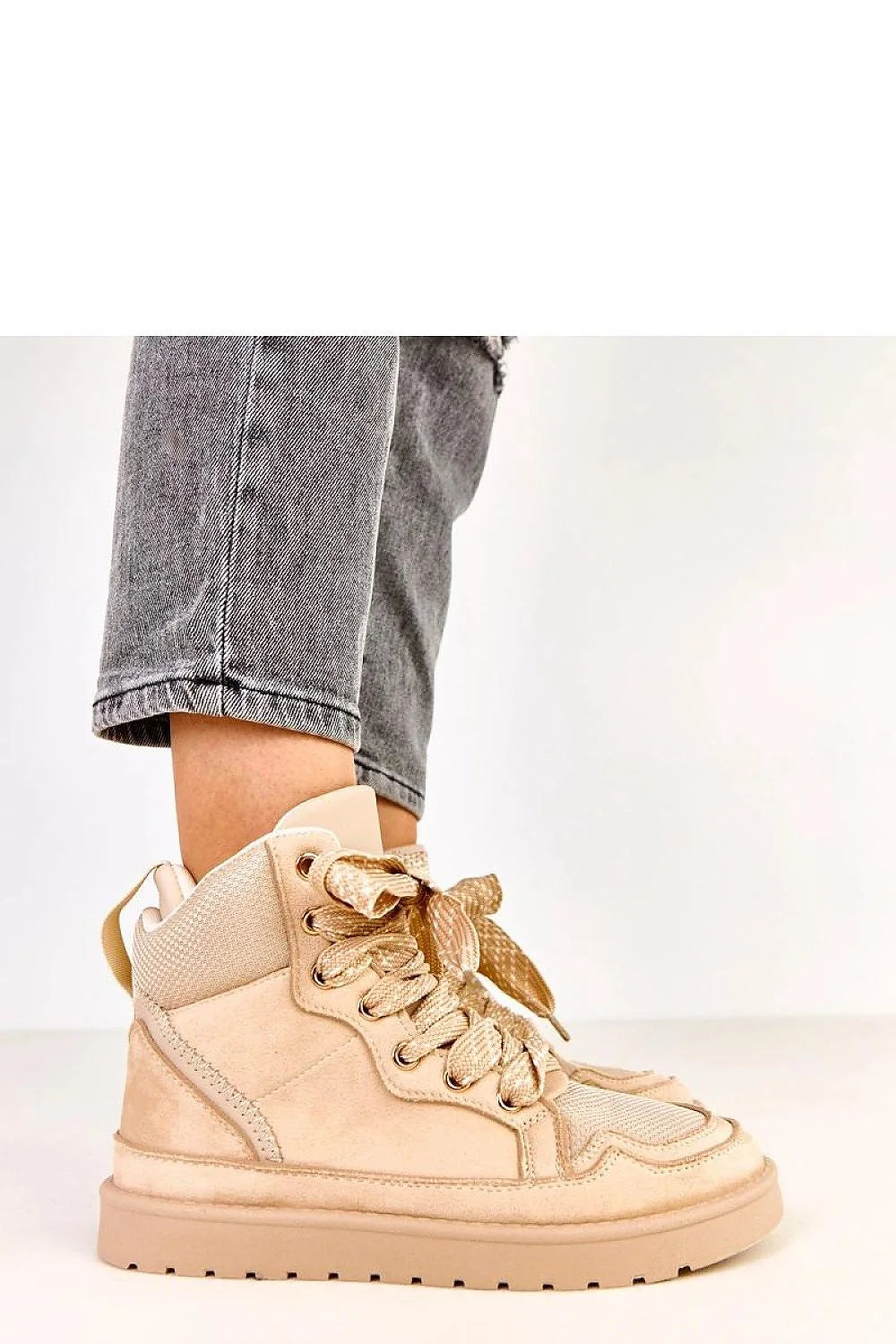 Close-up of the laces on beige sport shoes