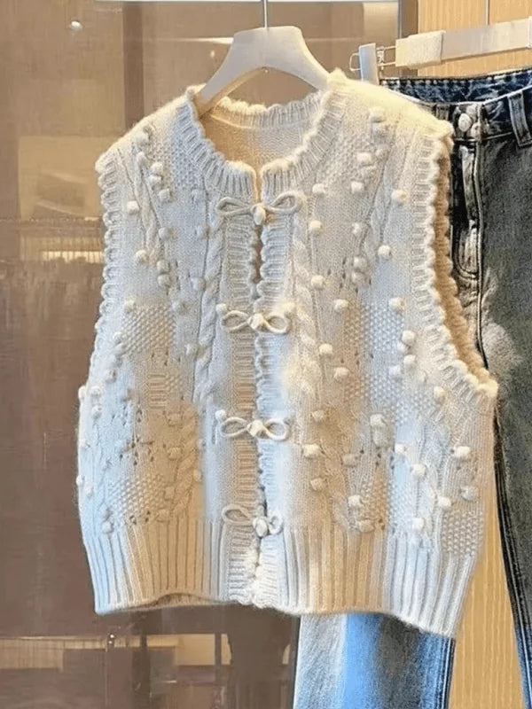 Close-up of the lace collar on a cream vest