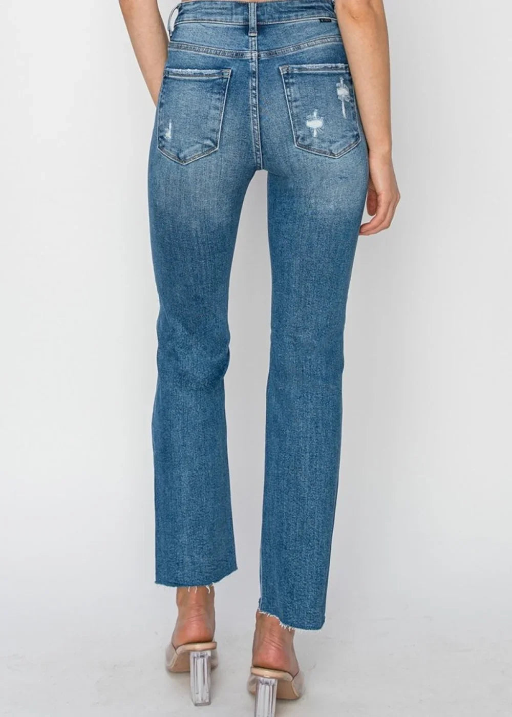 Close-up of distressed detail on ankle jeans