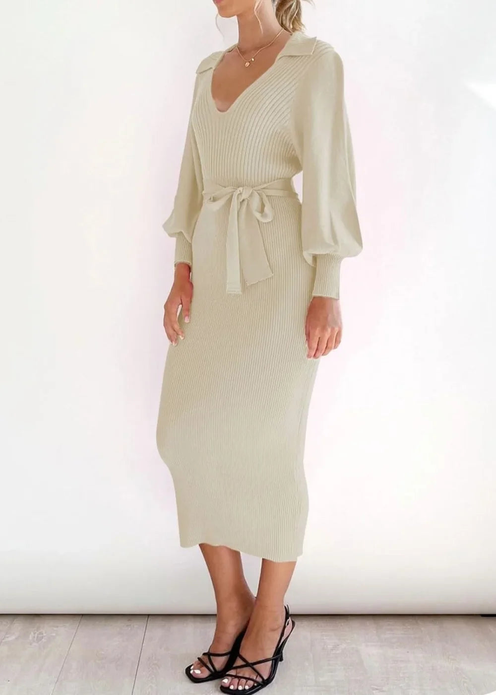 Close-up of the viscose fabric on a cream sweater dress