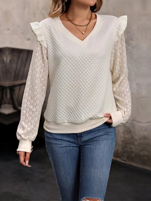 Cream quilted sweatshirt with lace sleeves and ruffled shoulders.