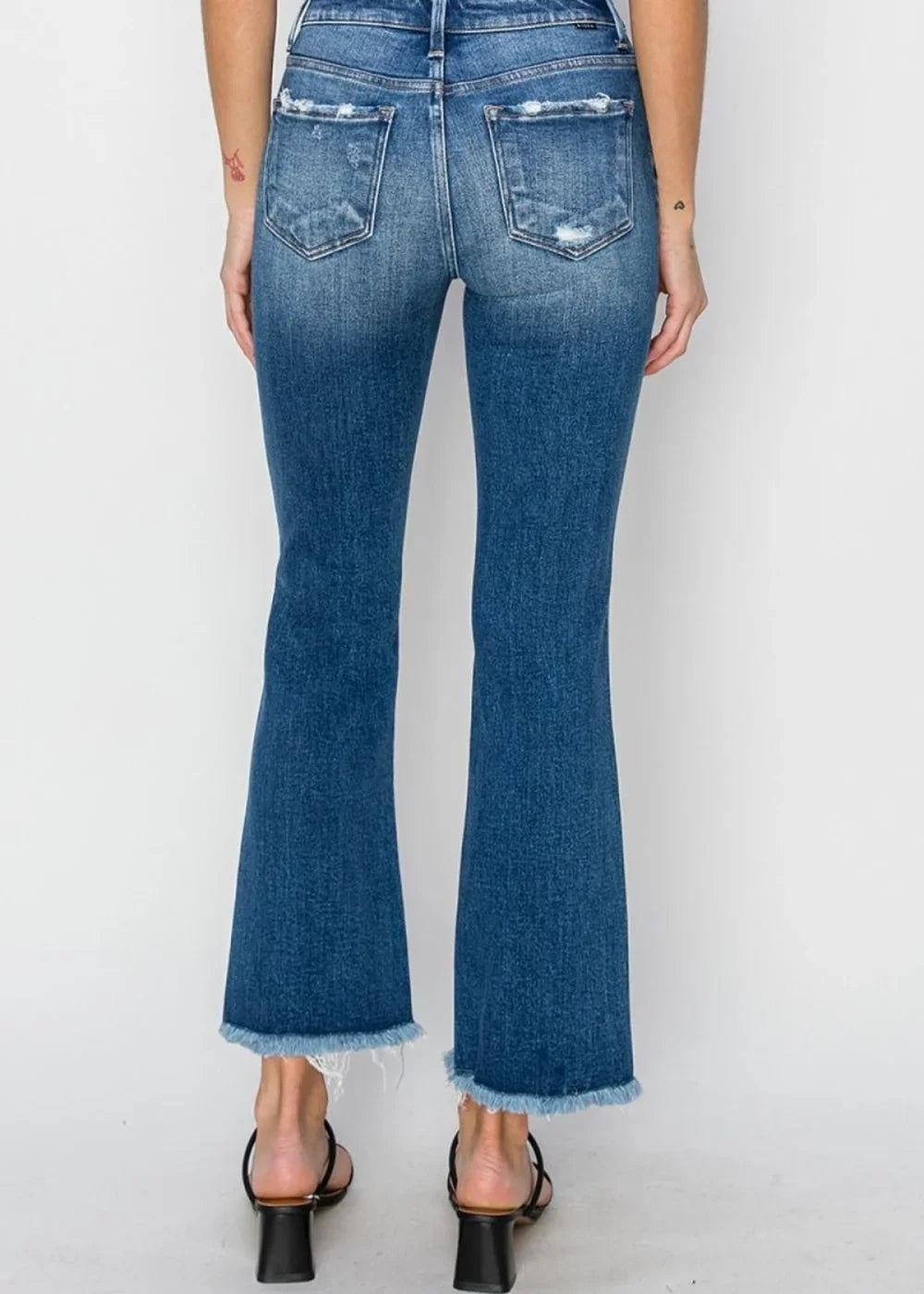 Close-up of frayed hem on flare jeans
