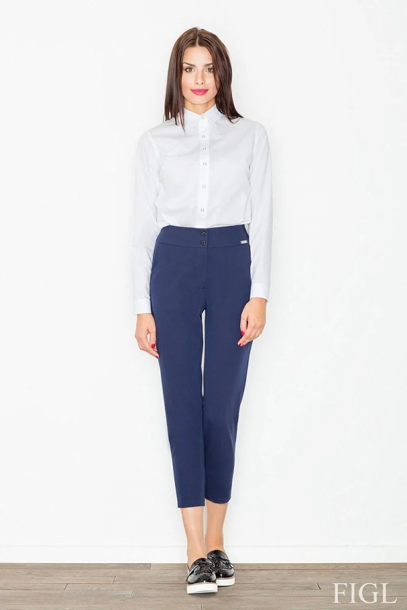 High-rise navy blue 7/8 length trousers with a fitted style on a model.