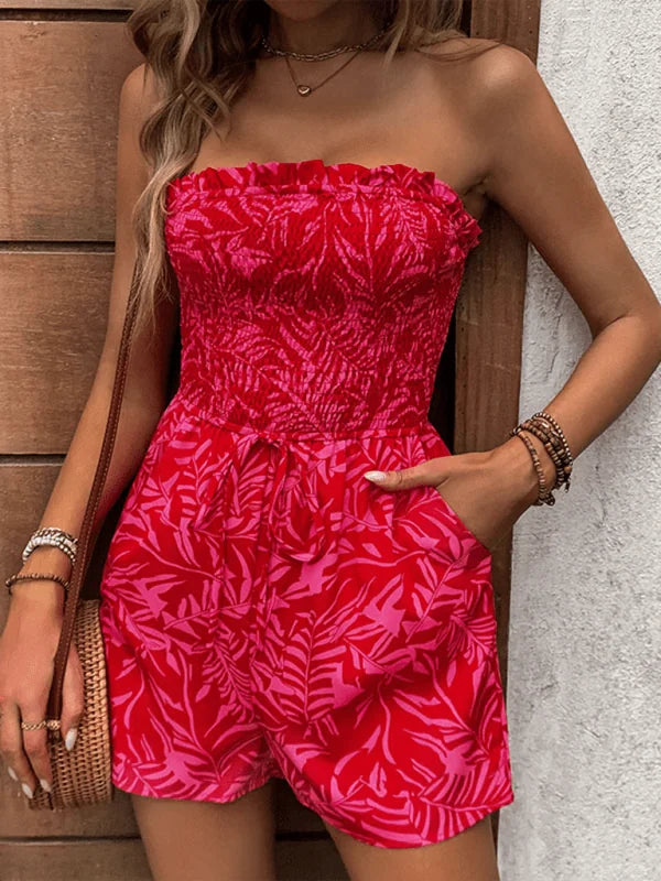 Red and pink leaf print strapless jumpsuit with smocked bodice and tie waist.