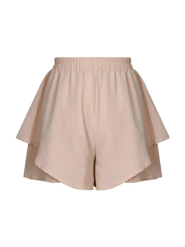 Light beige layered shorts with an elastic waistband and a textured fabric finish.