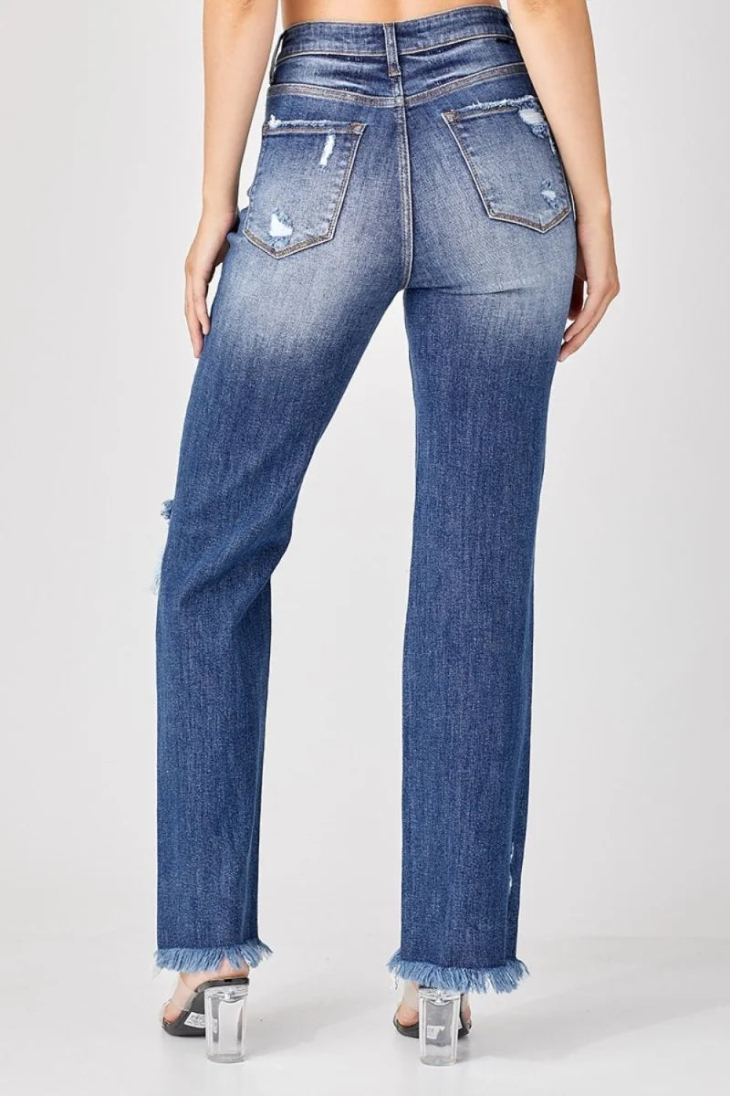 Distressed medium wash straight leg jeans with frayed hem and ripped details.