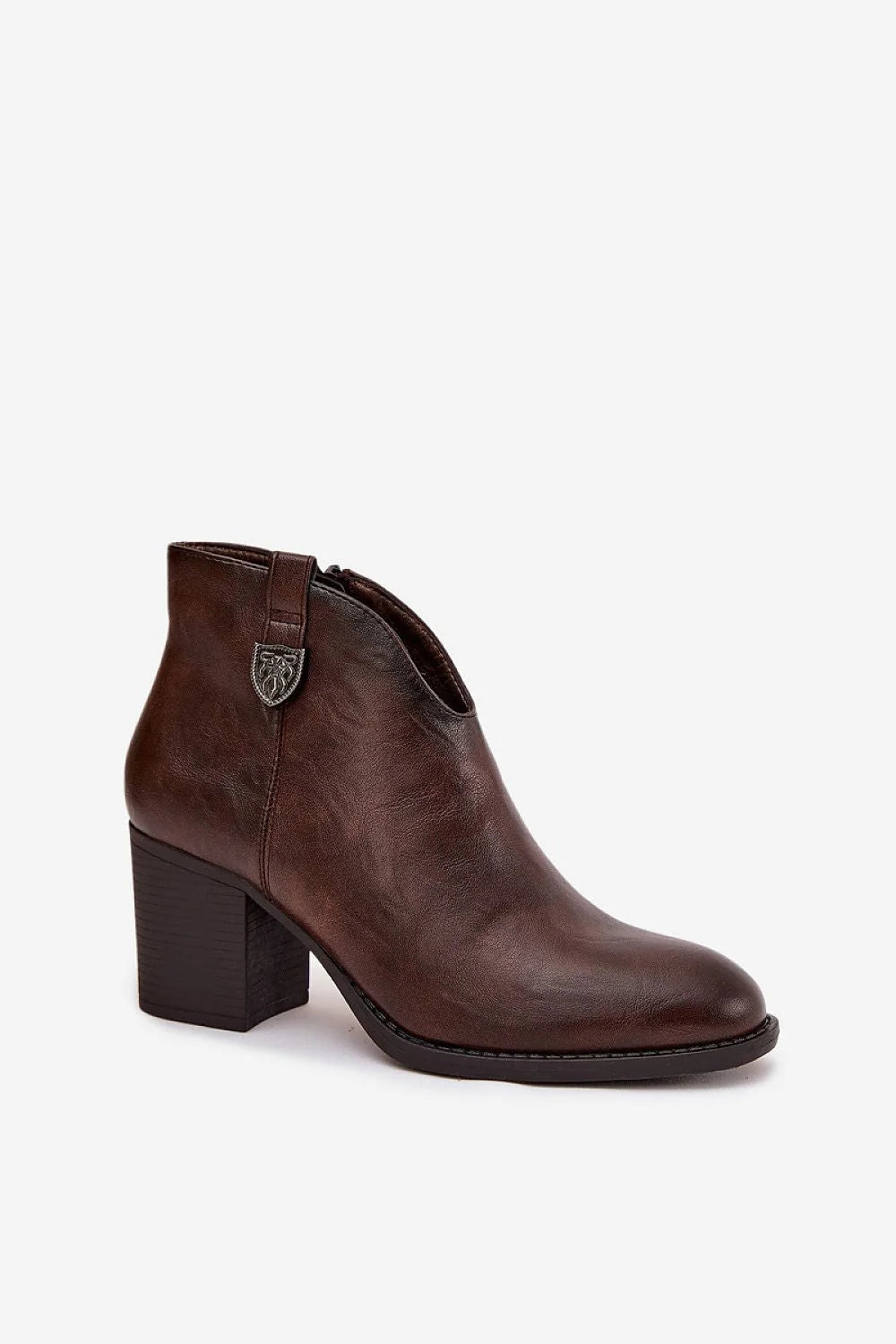 Brown leather ankle boot with a stacked heel and a decorative emblem on the side.