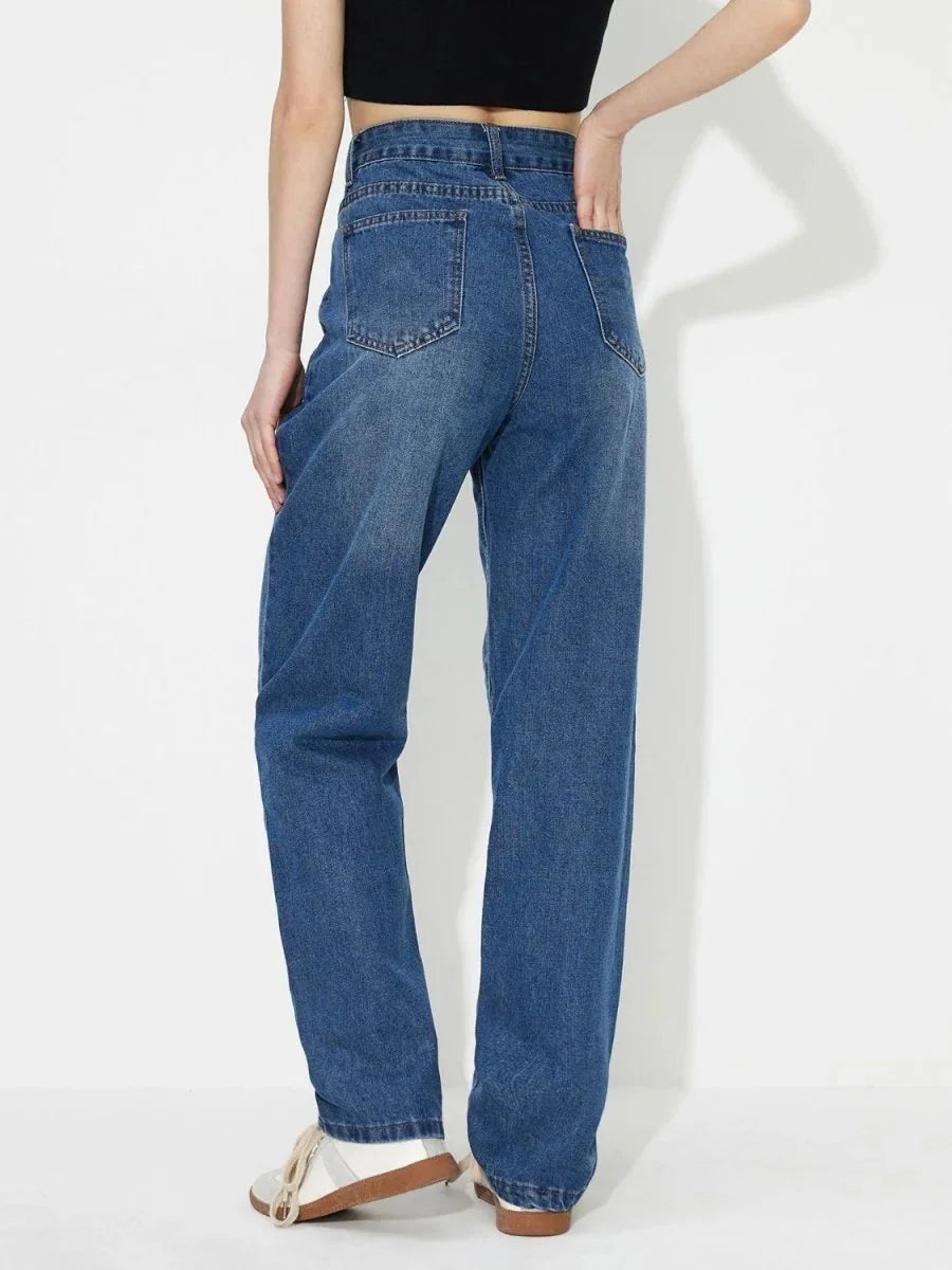 Back view of medium wash, regular fit denim jeans with visible stitching and pocket details.