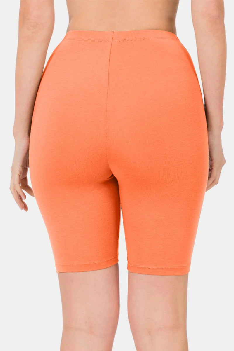 Back view of orange biker shorts with a smooth, stretchy texture.