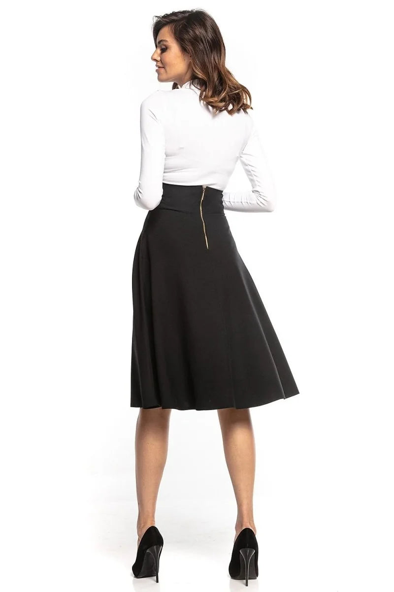 Detail of zipper on black midi skirt