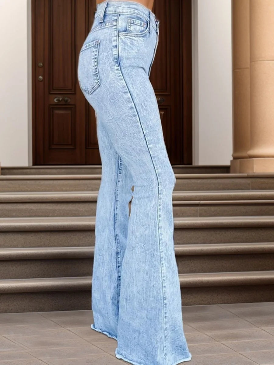 Close-up of the raw hem detail on the jeans.