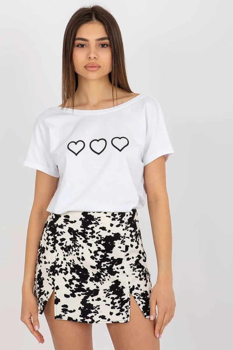 White t-shirt with three black hearts and a black and white abstract print mini skirt with thigh slits, on model.