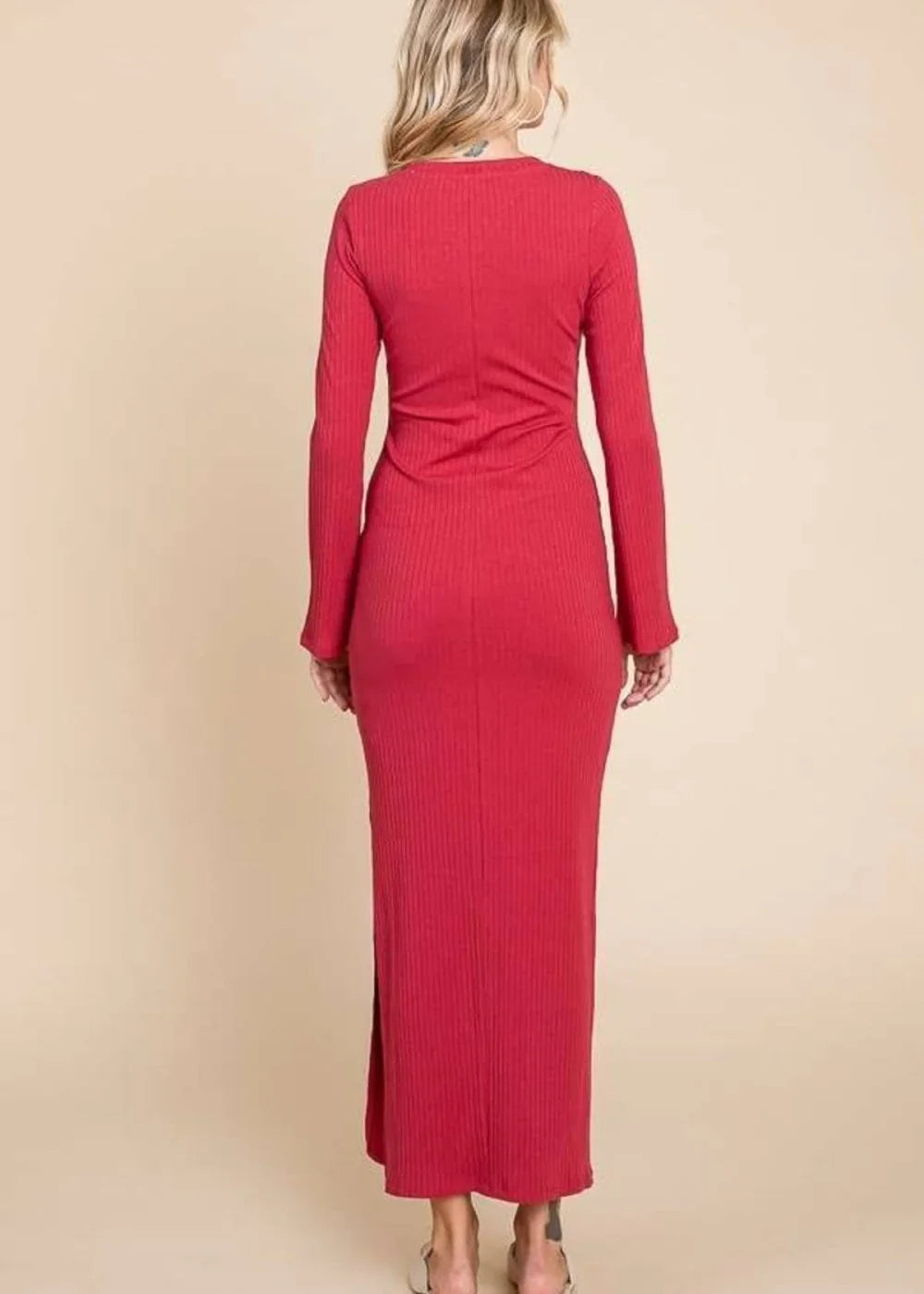 Red ribbed knit bodycon maxi dress with long sleeves, side slit, shown from the back on a model.