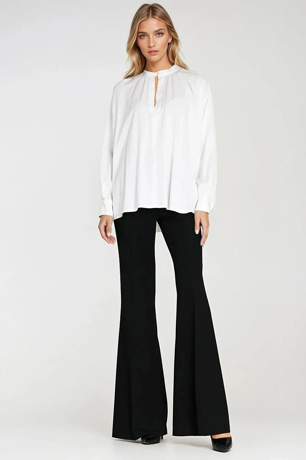 Detail of ruching on beige blouse sleeve