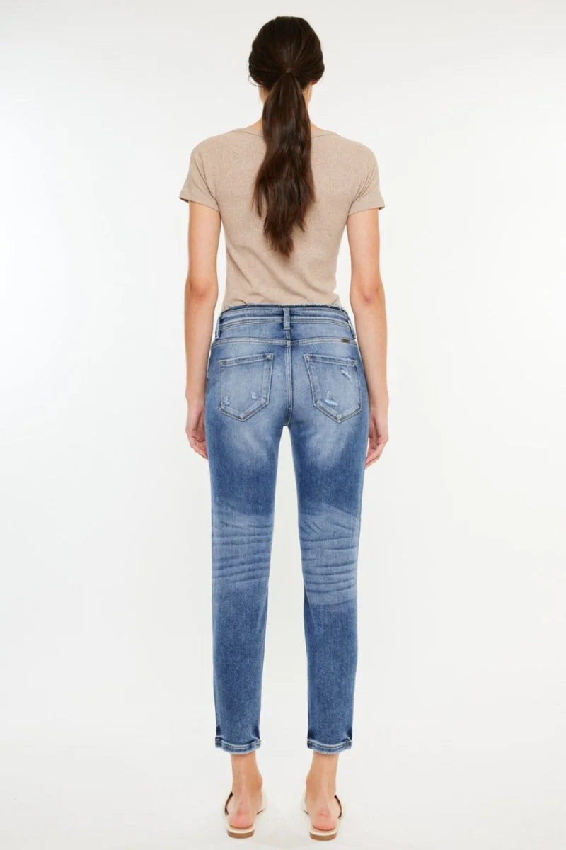 Back view of medium wash, slightly stretchy, distressed denim jeans with a relaxed fit.