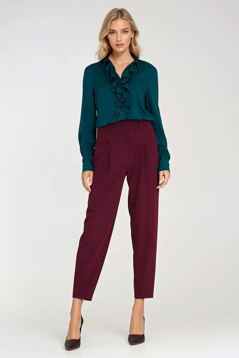 Detail of large front pockets on red trousers