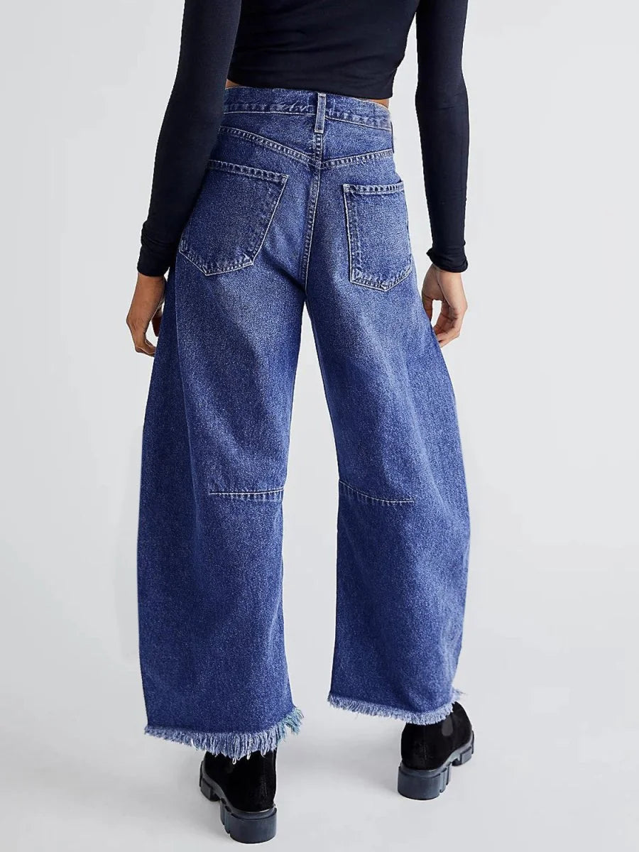 Close-up of the raw hem on wide leg jeans