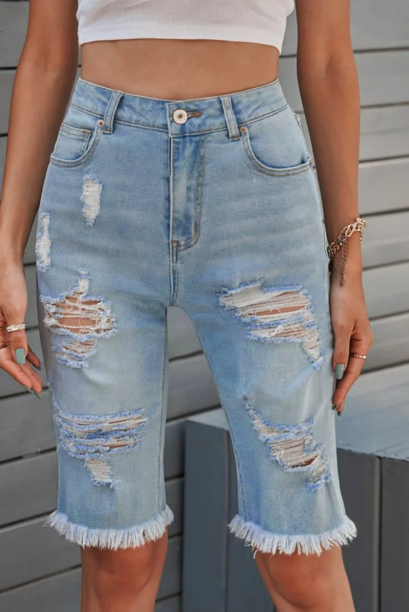 Light blue distressed denim shorts with frayed hem and ripped details.