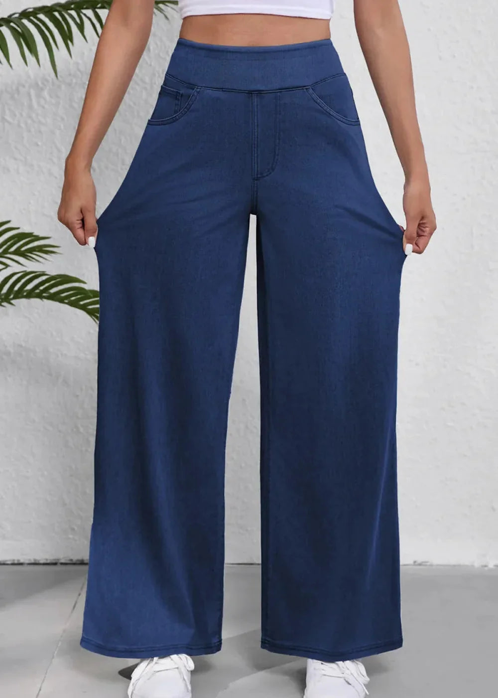 Navy blue wide-leg pants made of soft, stretchy denim with a relaxed fit and faux pockets.