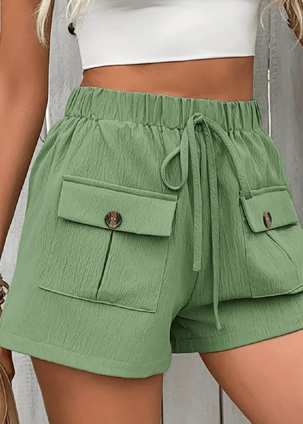 Close-up of pocket detail on green shorts