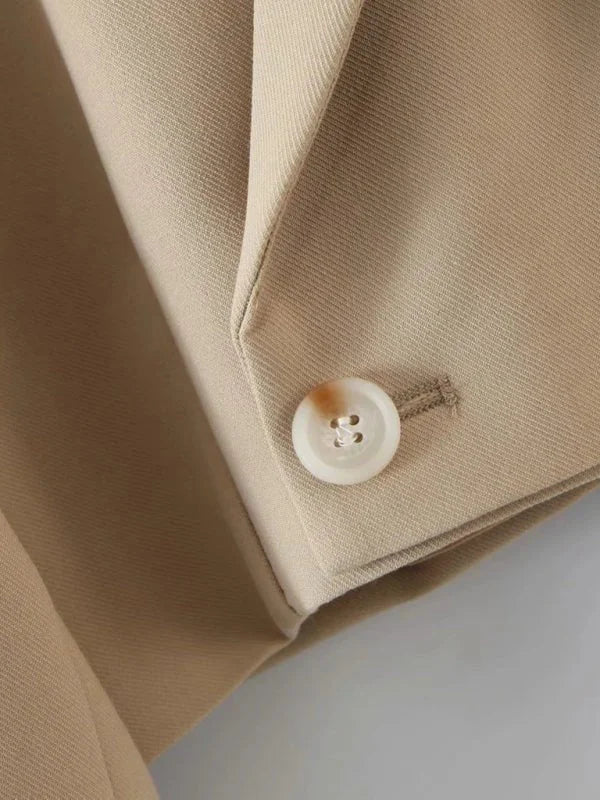 White diagonal button blazer and pocket skirt suit