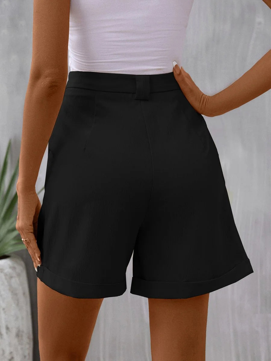 Close-up of pocket detail on black shorts