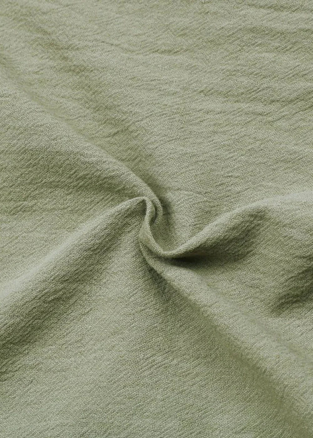 Detail of decorative buttons on a green romper