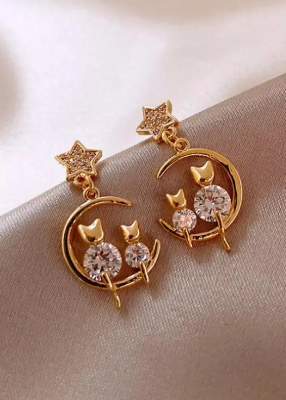 Close-up of cat's eye stone on gold-plated earrings
