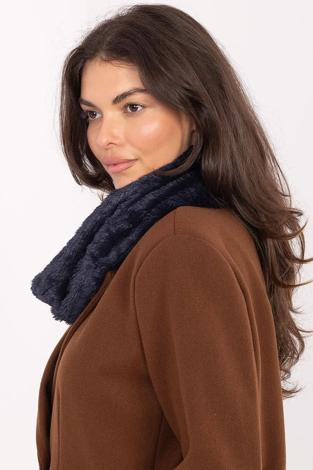 Close-up of a woman wearing a brown coat with a fuzzy navy blue scarf.