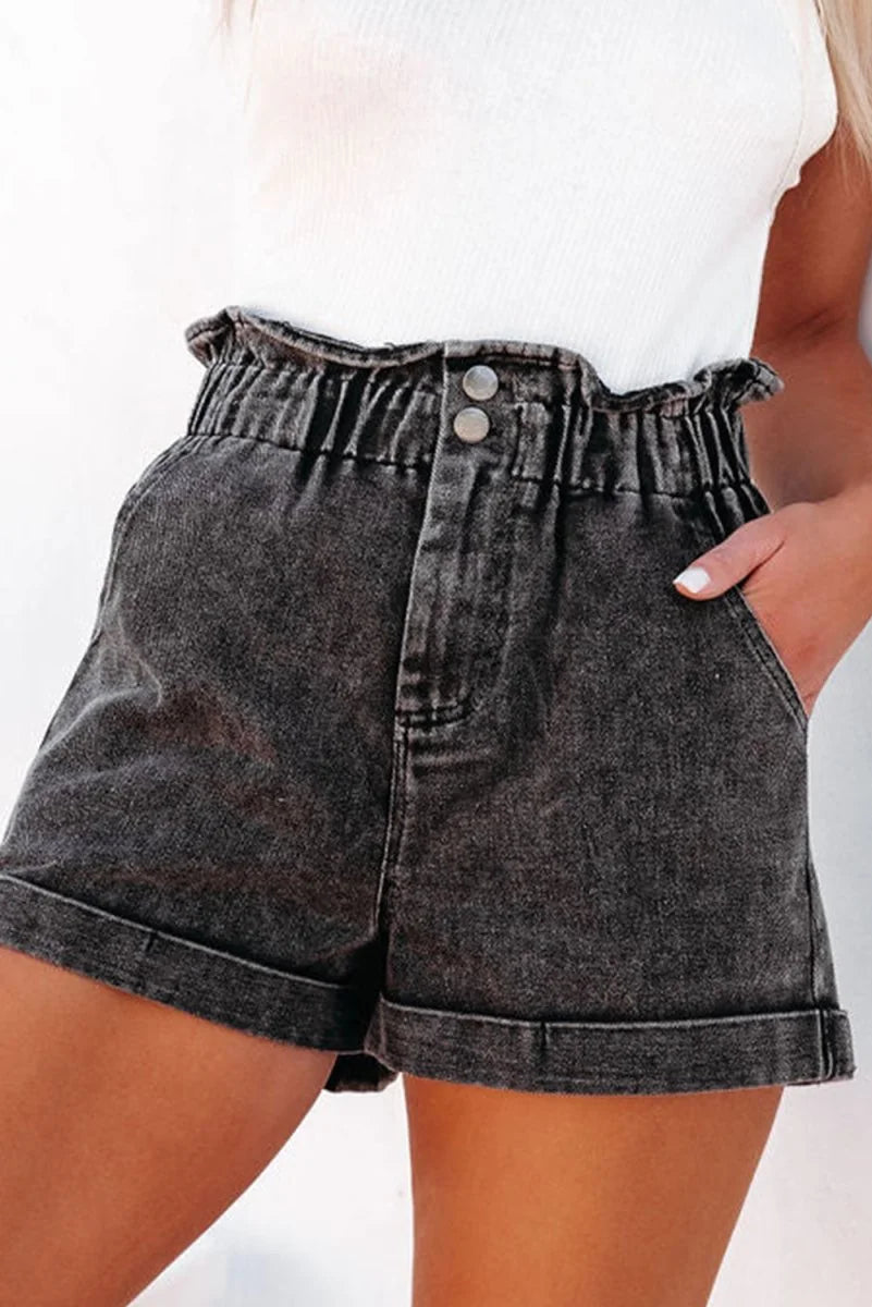 Close-up of paperbag waist detail on denim shorts