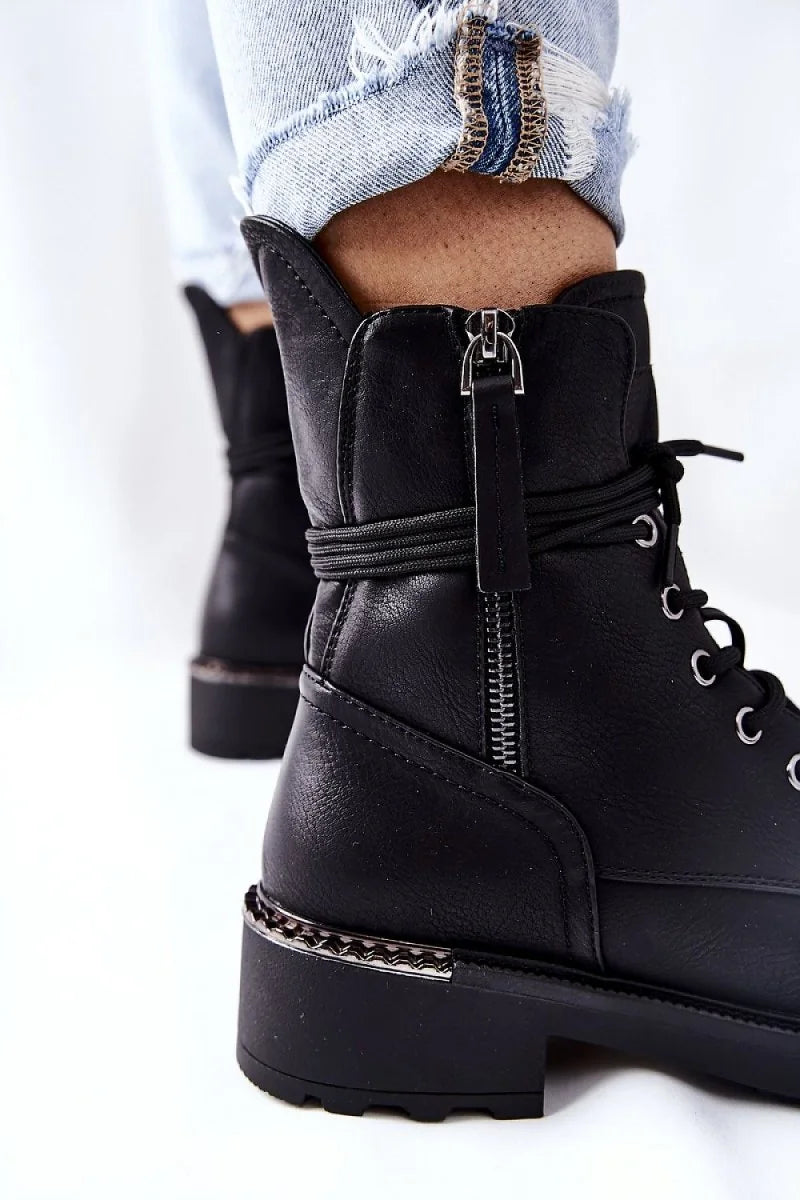 Close-up of the decorative heel detail on black boots