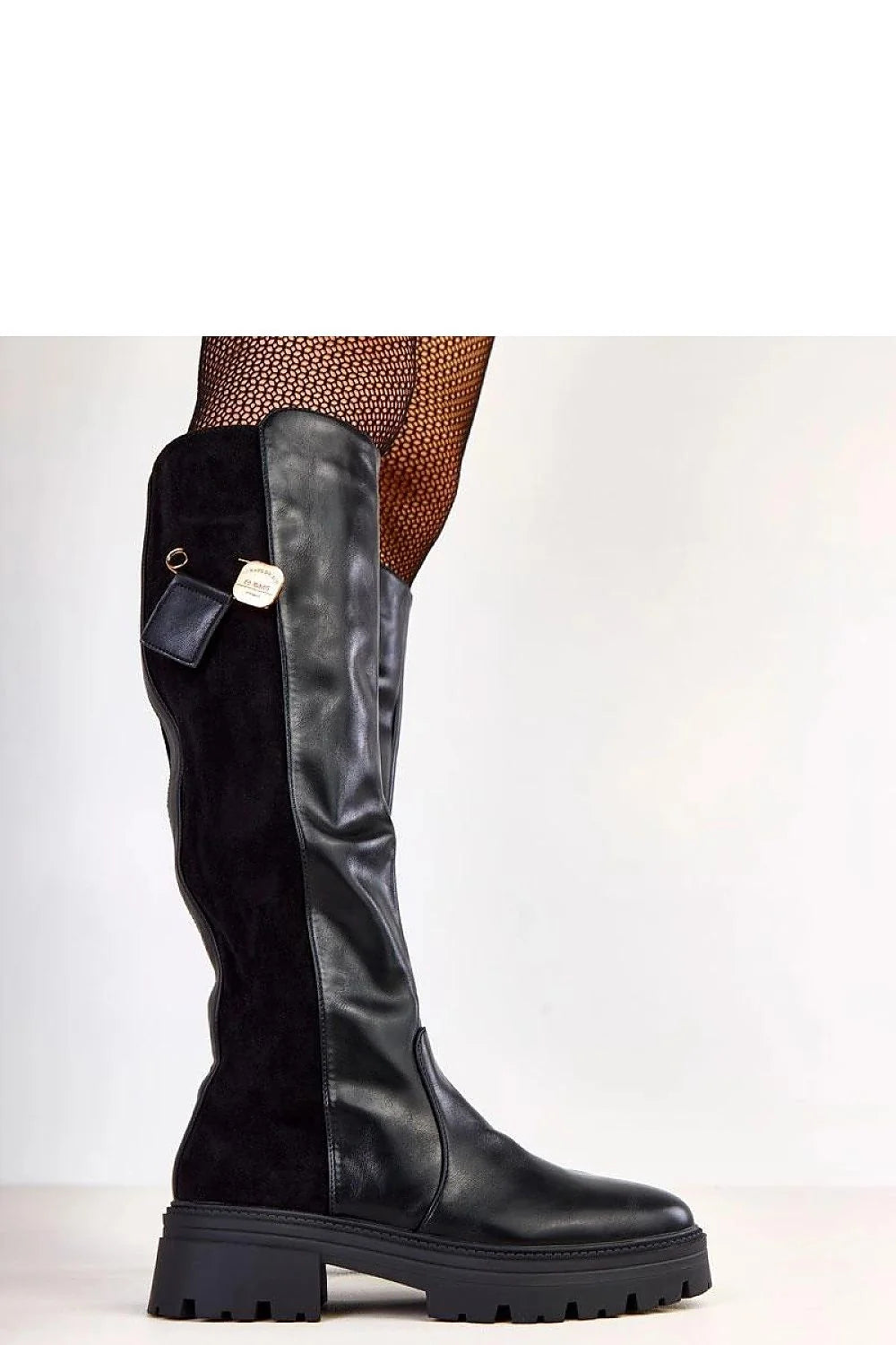 Close-up of women's black synthetic leather boots