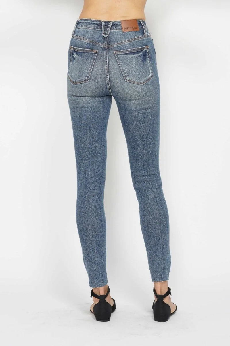 Close-up of the distressed hem on the skinny jeans.