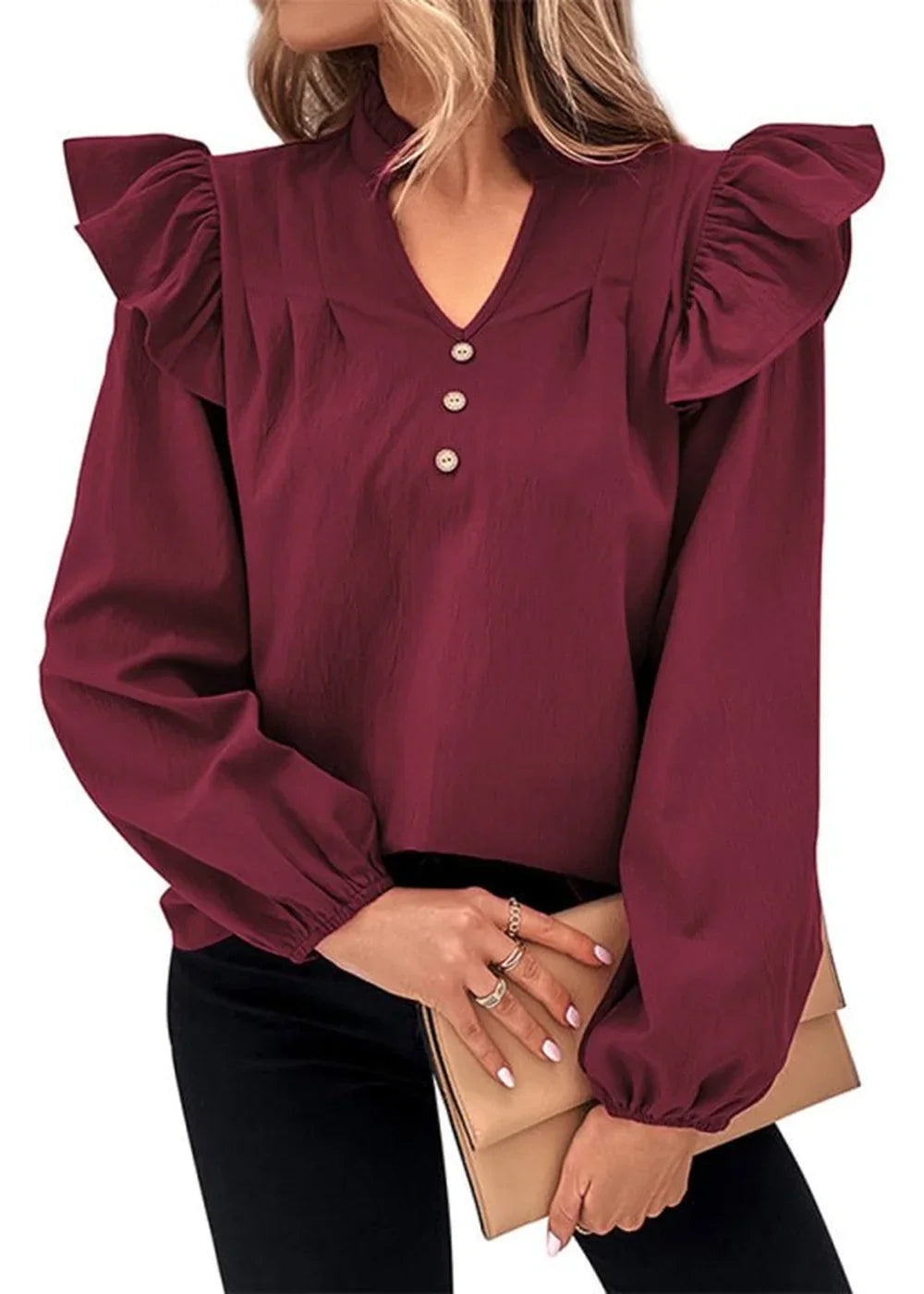 Maroon long-sleeve top with ruffled shoulders and v-neck with three buttons.