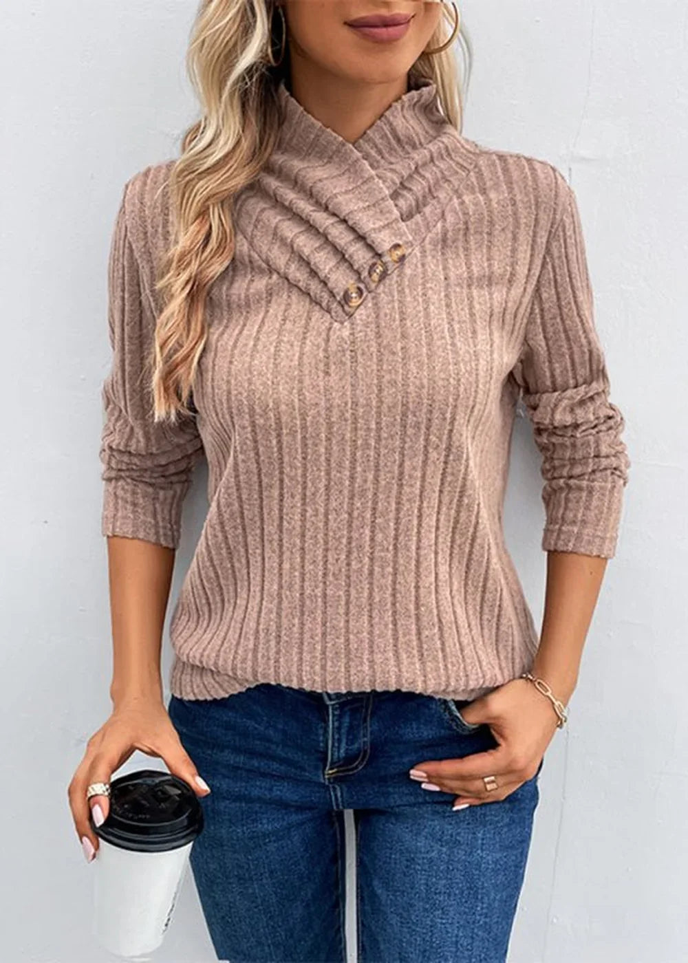 Brown ribbed turtleneck sweater with button detail and ruched sleeves on a model.