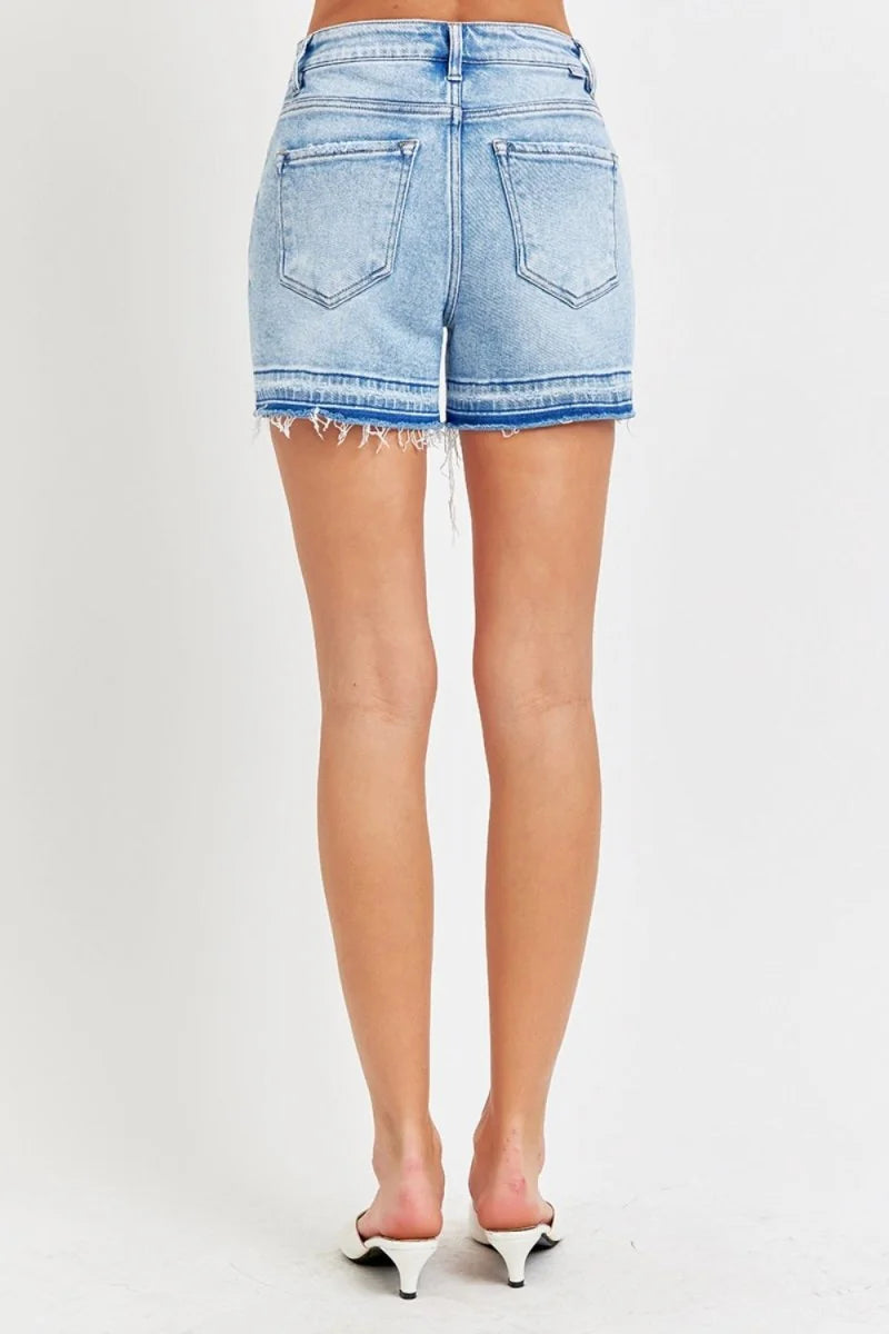 Light wash high-rise denim shorts with frayed, layered hems.