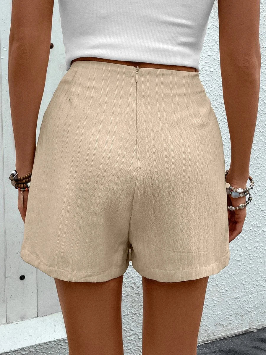 Model wearing tan high waist shorts