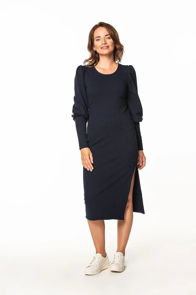 Navy blue cotton-blend midi dress with puff sleeves and a thigh-high slit, worn with white sneakers.