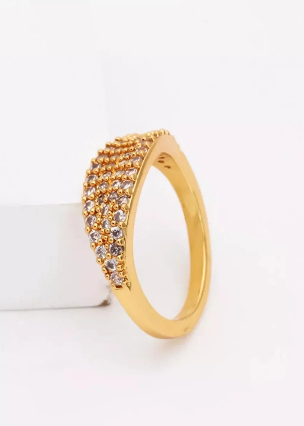 Gold-plated ring with rows of clear and champagne-colored zircon stones, set against a white background.