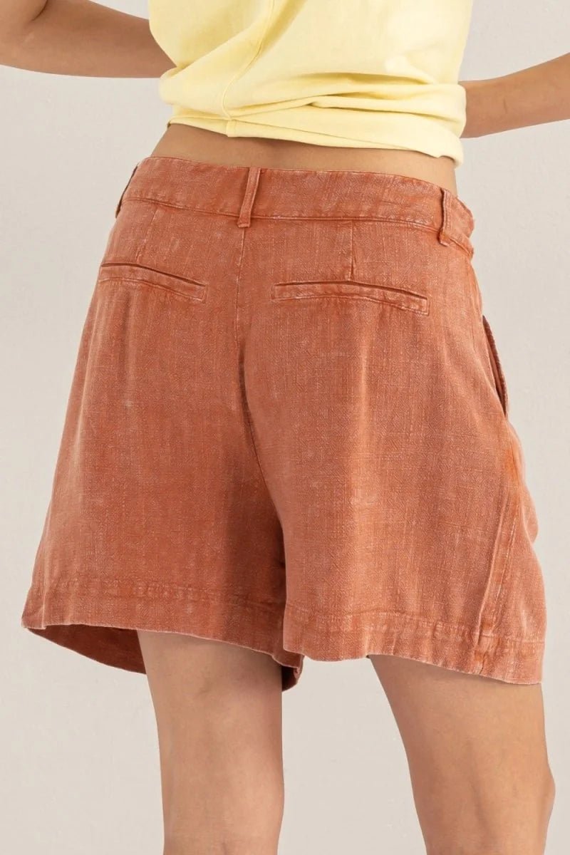 Back view of rust-colored linen-blend shorts with a regular fit and subtle texture.