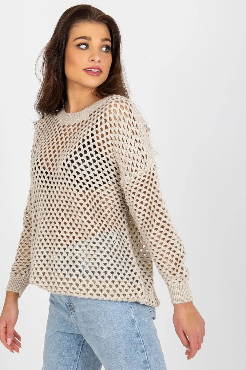 Beige crochet knit sweater with a relaxed fit and crew neck on a model.