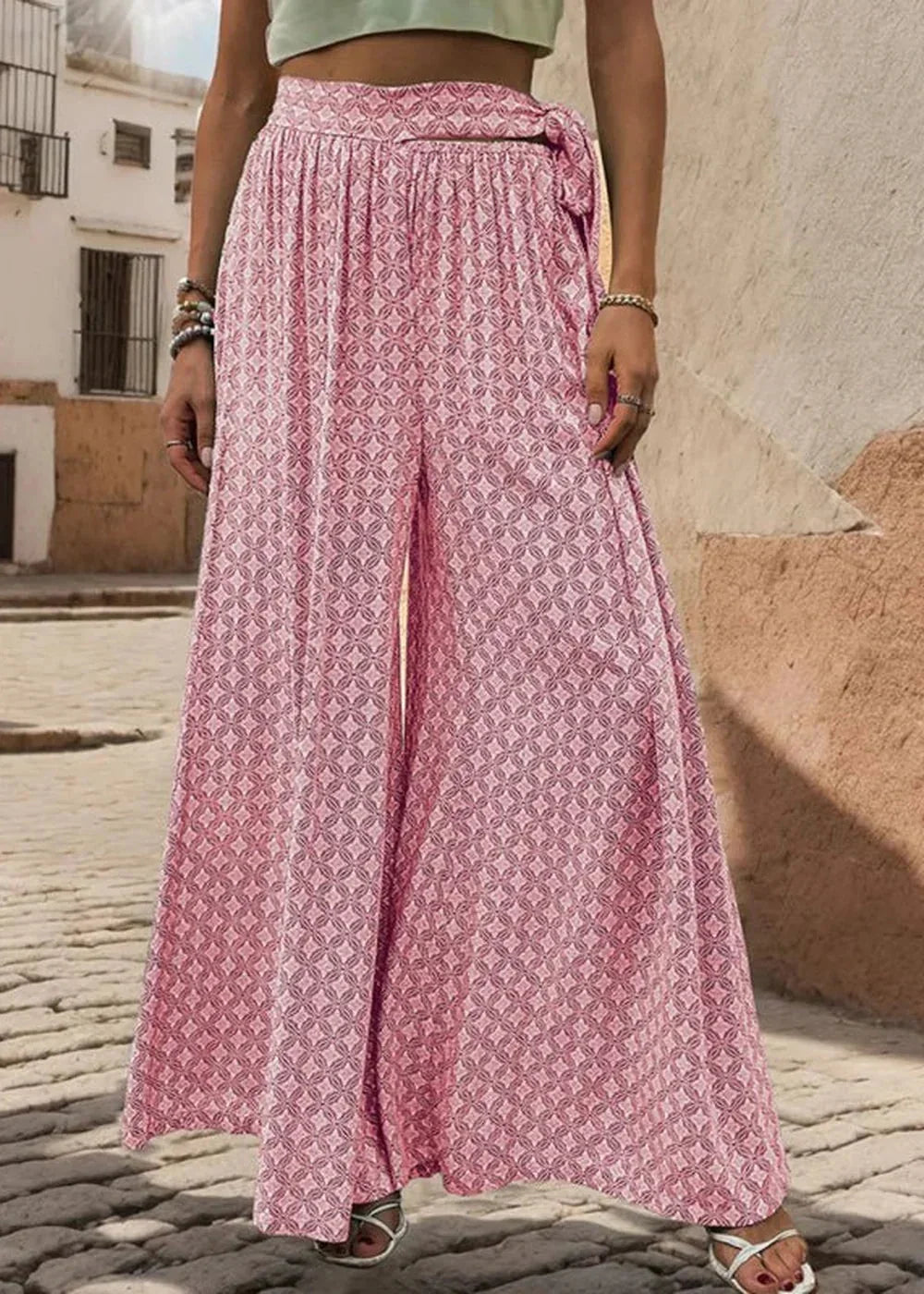 Model wearing pink wide-leg trousers
