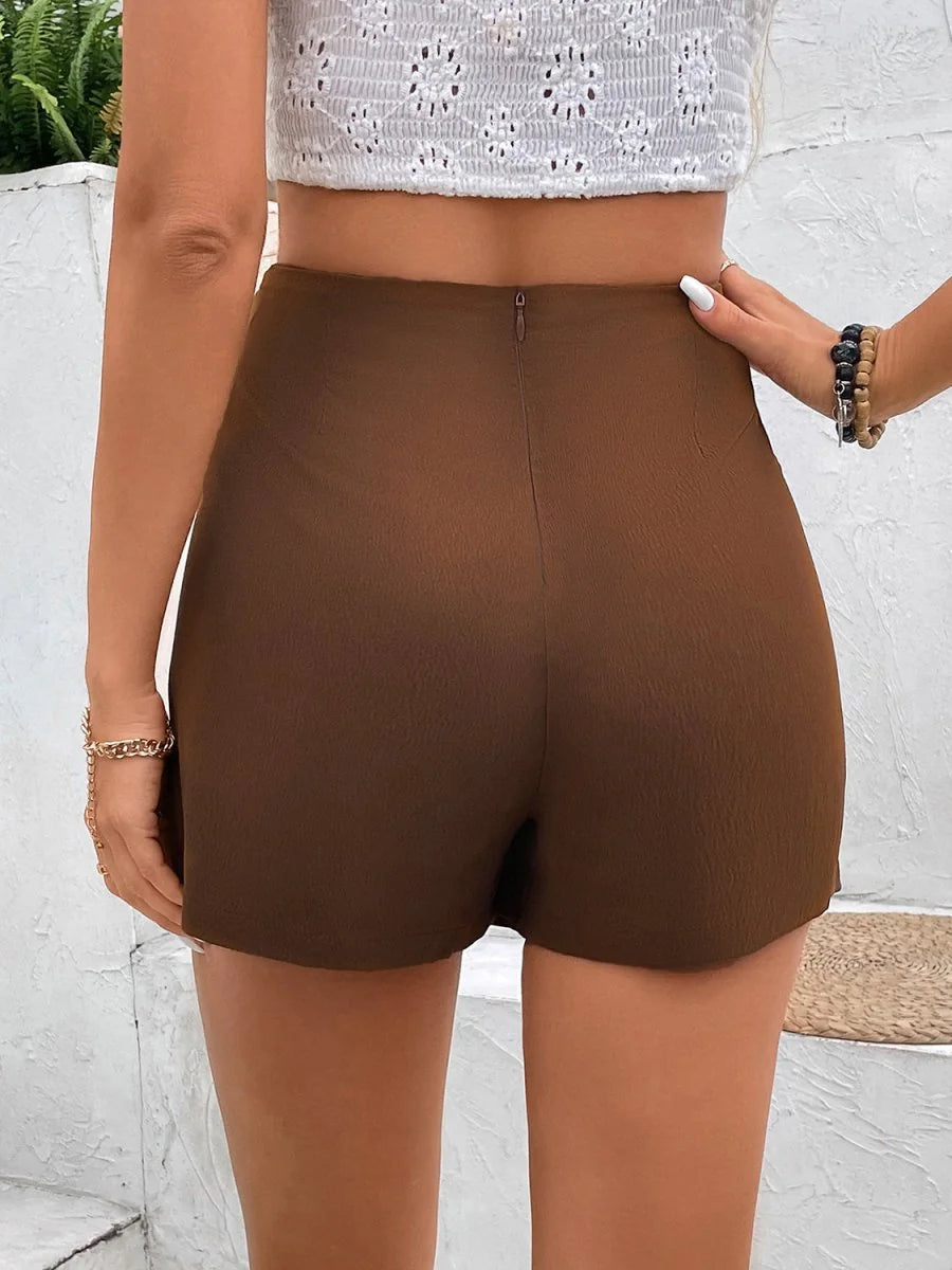 Close-up of the pocket detail on brown shorts