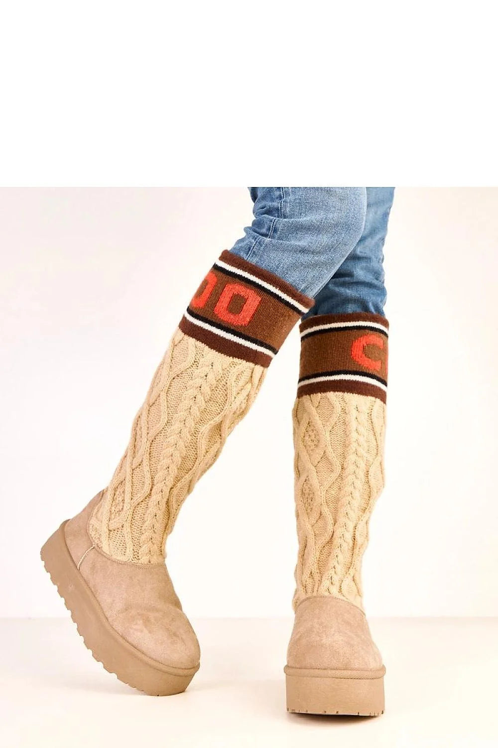 Beige knit boot cuffs with brown and orange trim over tan faux suede boots.