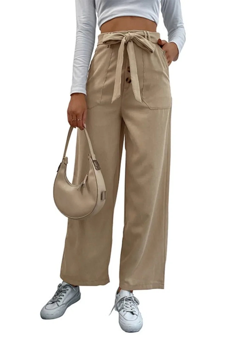 Beige wide-leg pants with a self-tie belt, button closure, and side pockets, worn by a model with white sneakers.