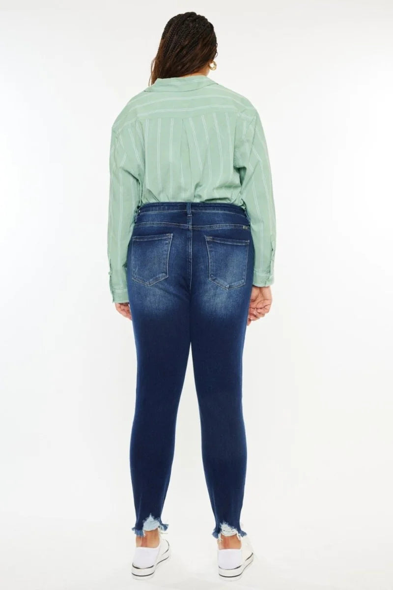 Dark wash denim jeans with frayed hem and subtle distressing, shown from the back.